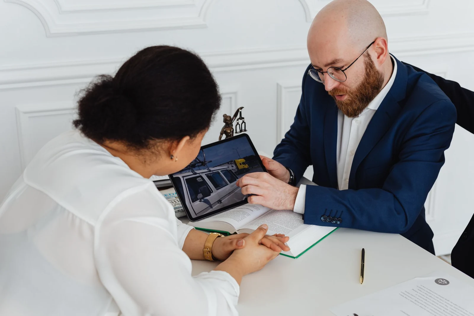 Professionals review a digital record alongside written case notes.
